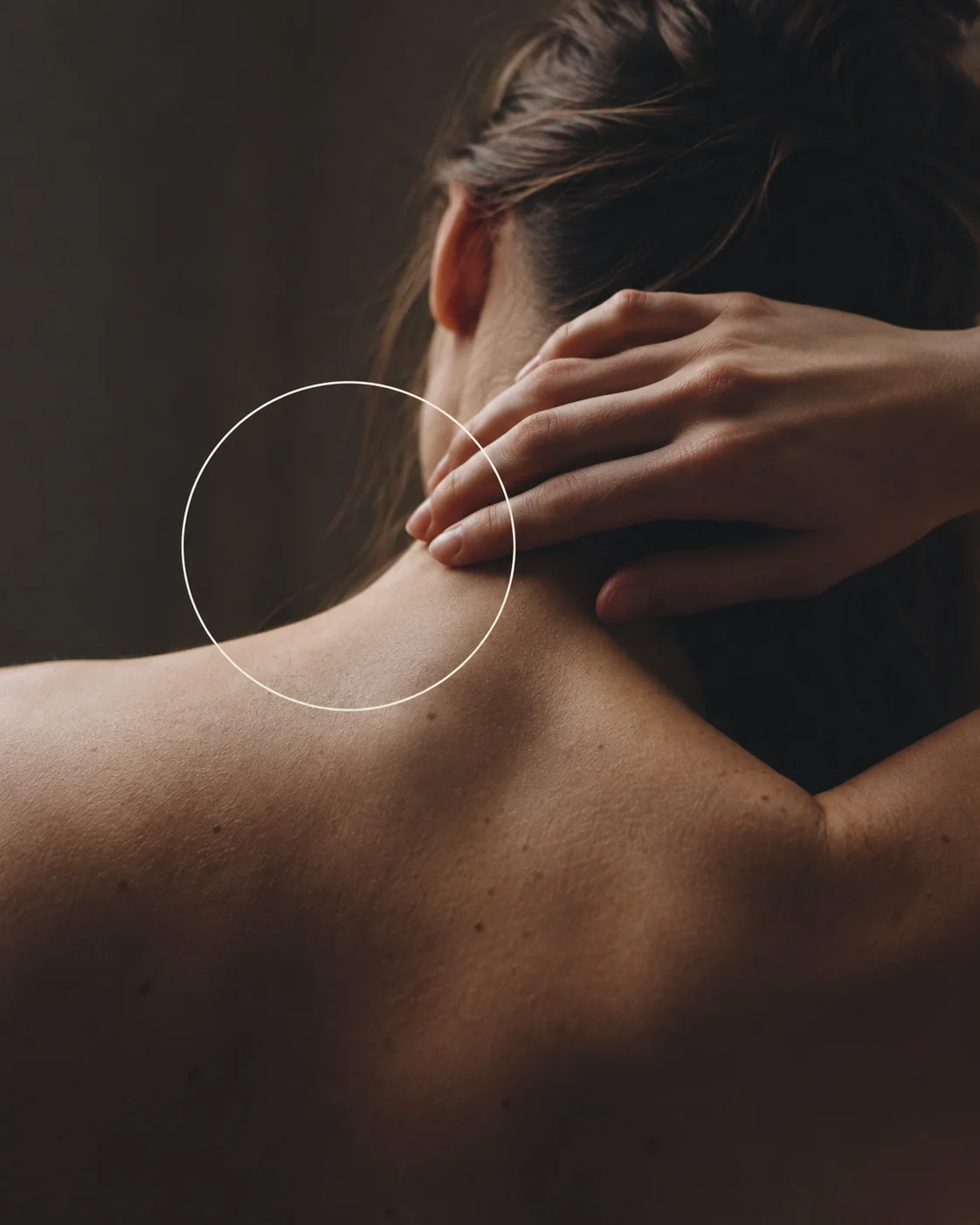 A slow stretch — shoulder and neck in soft shadow