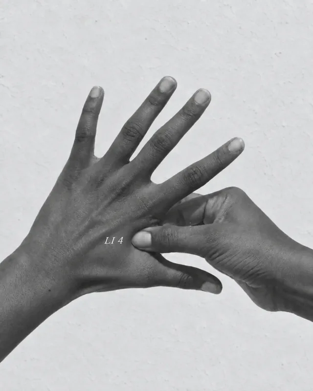 One hand pressing the other in black and white